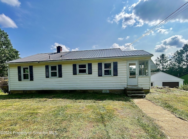 rear view of house featuring a lawn