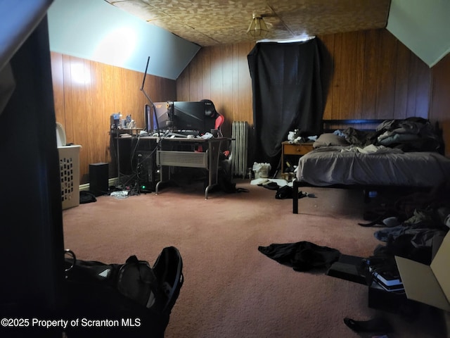 carpeted bedroom featuring lofted ceiling, radiator, and wood walls