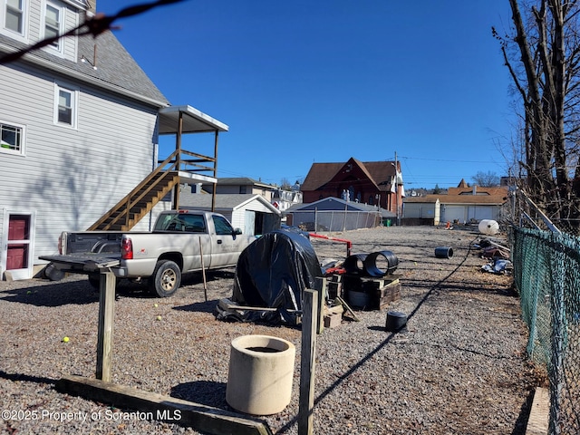 view of yard with stairway and fence