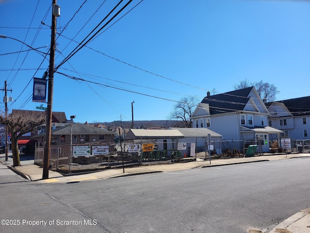 view of building exterior with a residential view and fence