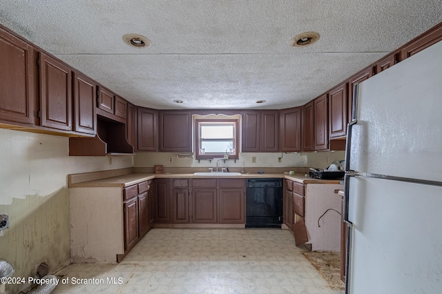 kitchen with sink, white fridge, and black dishwasher