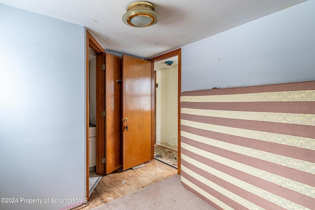 hallway with light colored carpet