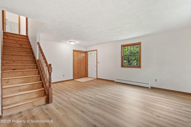 67 Smith Dr, Hallstead, PA 18822 - unfurnished living room featuring a baseboard heating unit, light wood finished floors, stairs, and baseboards