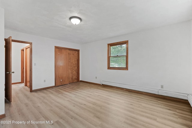 67 Smith Dr, Hallstead, PA 18822 - unfurnished bedroom featuring light wood-type flooring, baseboards, a closet, and a baseboard heating unit