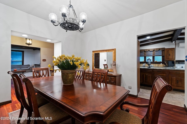 dining area with vaulted ceiling with beams, a chandelier, and hardwood / wood-style flooring