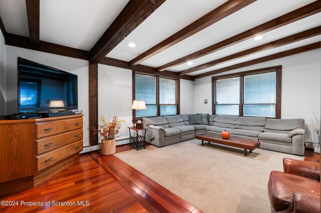 living room with beam ceiling, baseboard heating, and wood-type flooring