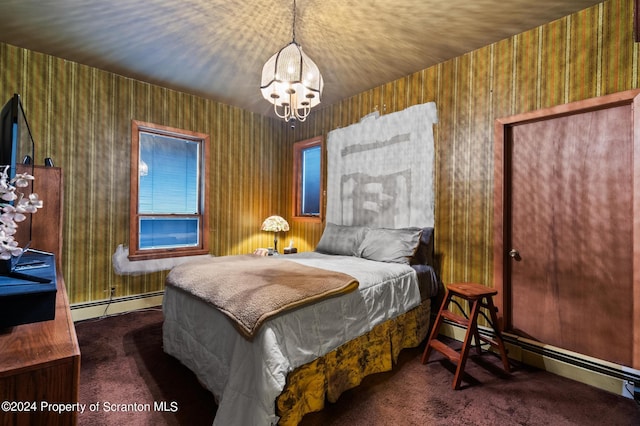 carpeted bedroom featuring a chandelier and baseboard heating