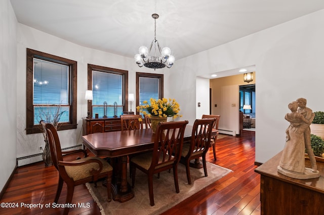 dining room with dark hardwood / wood-style floors, a baseboard heating unit, and an inviting chandelier