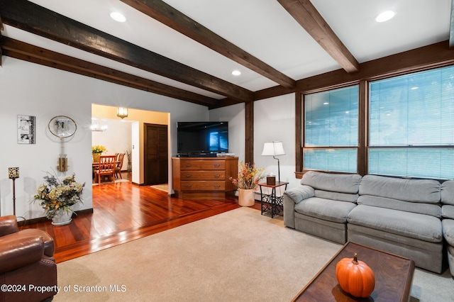 living room with vaulted ceiling with beams and wood-type flooring