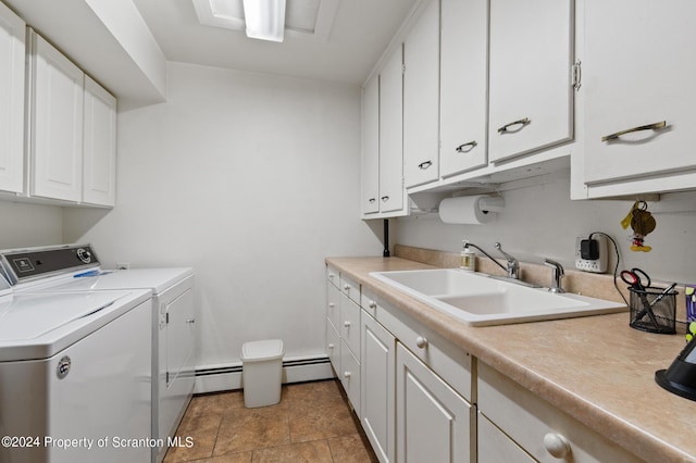 clothes washing area with sink, cabinets, and independent washer and dryer