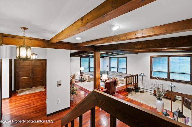 hallway with beamed ceiling, a notable chandelier, and hardwood / wood-style flooring