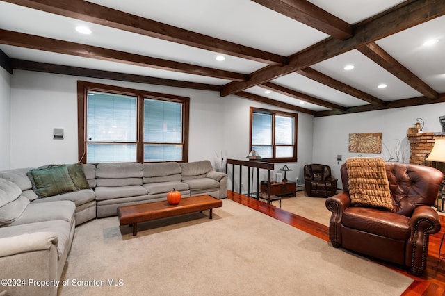 living room with vaulted ceiling with beams and light colored carpet