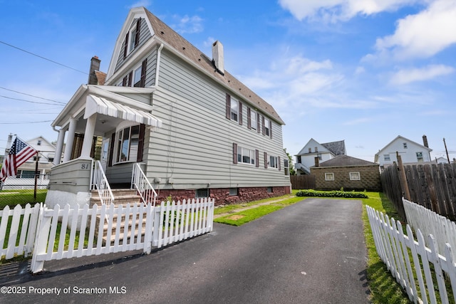 81 Rees St, Wilkes-Barre, PA 18702 - view of home's exterior featuring a chimney and driveway