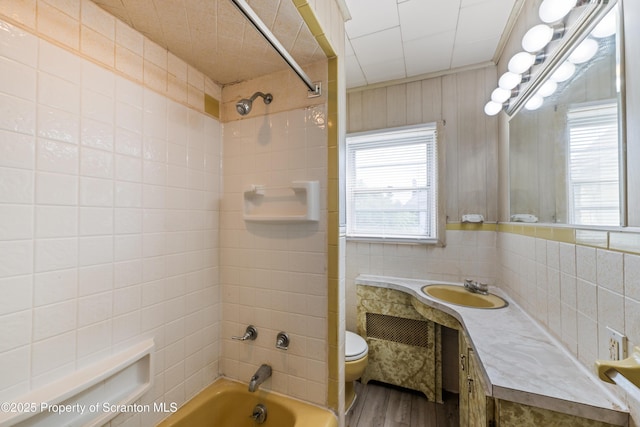81 Rees St, Wilkes-Barre, PA 18702 - bathroom with toilet, shower / bathtub combination, vanity, wood finished floors, and tile walls
