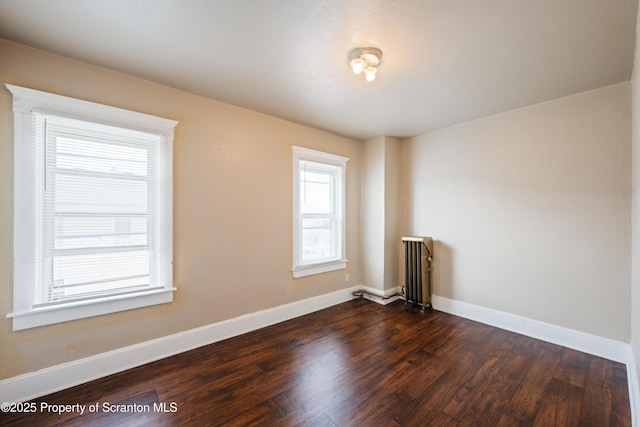 81 Rees St, Wilkes-Barre, PA 18702 - empty room featuring dark wood finished floors, baseboards, and radiator heating unit