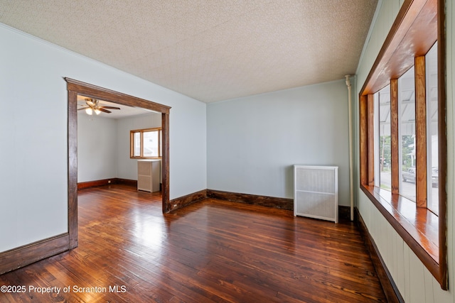 81 Rees St, Wilkes-Barre, PA 18702 - unfurnished room with radiator heating unit, hardwood / wood-style floors, a textured ceiling, baseboards, and ceiling fan
