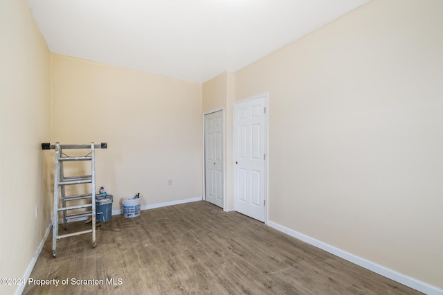 empty room with hardwood / wood-style floors