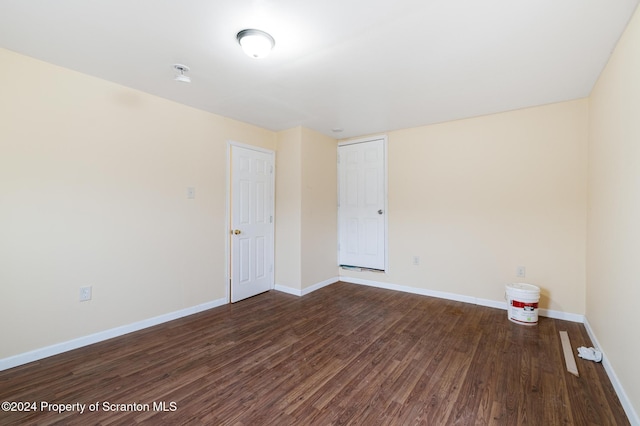 spare room with dark hardwood / wood-style flooring