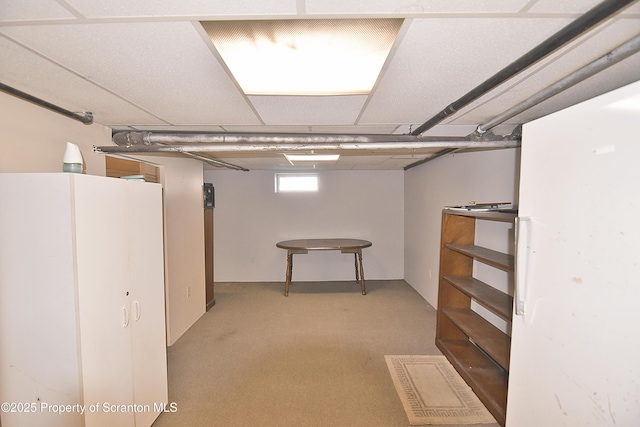 basement featuring light carpet