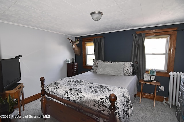 carpeted bedroom with baseboards, ornamental molding, and radiator