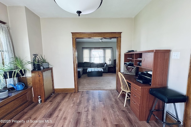 office space with baseboards and wood finished floors