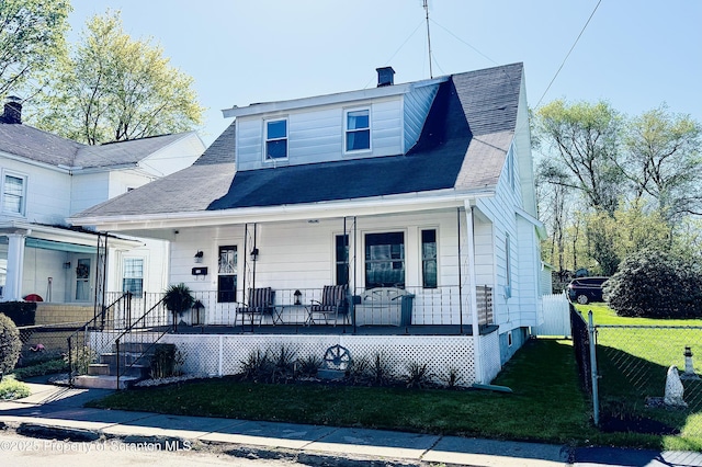bungalow-style house featuring a porch, a chimney, fence, a front lawn, and a shingled roof