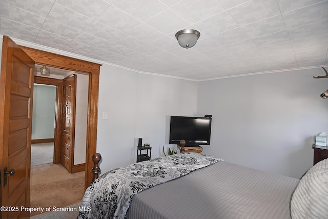carpeted bedroom with ornamental molding