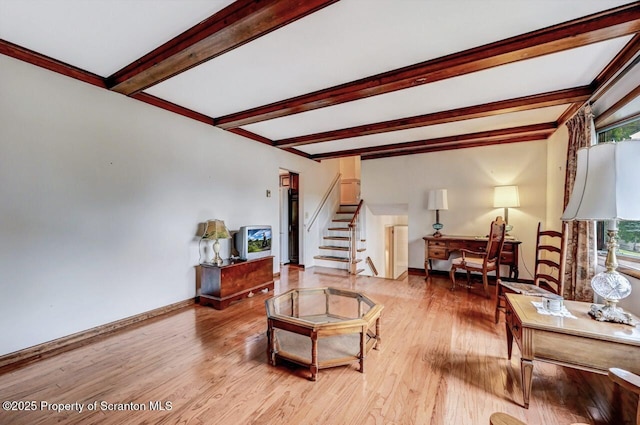 living room with light hardwood / wood-style floors and beam ceiling