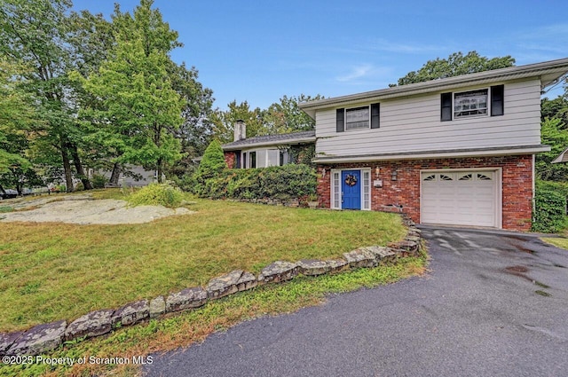 split level home featuring a garage and a front yard