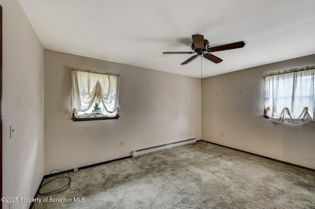 empty room with ceiling fan, baseboard heating, and light colored carpet