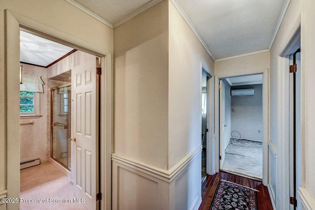 hallway with a wall mounted AC, a baseboard heating unit, crown molding, and hardwood / wood-style floors