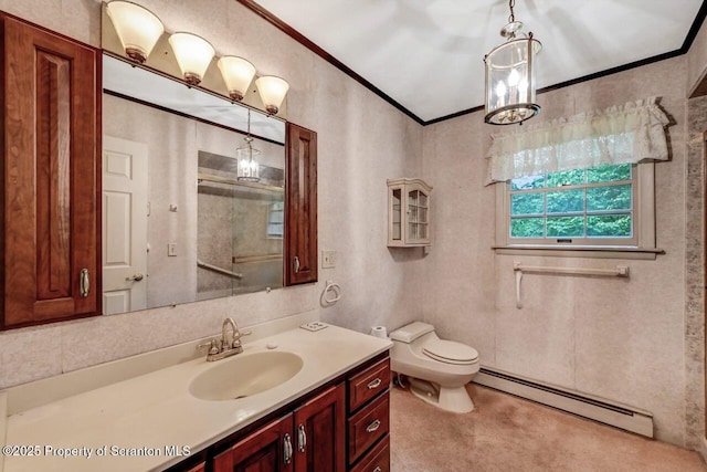 bathroom with toilet, vanity, crown molding, and a baseboard radiator