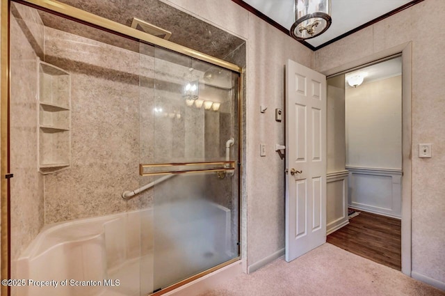 bathroom with crown molding and an enclosed shower