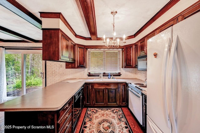 kitchen with kitchen peninsula, an inviting chandelier, white appliances, and pendant lighting