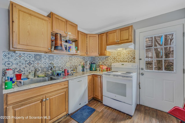 kitchen featuring white appliances, dark wood-type flooring, backsplash, ornamental molding, and sink