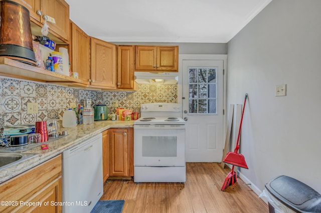 kitchen featuring light hardwood / wood-style flooring, backsplash, white appliances, light stone counters, and crown molding