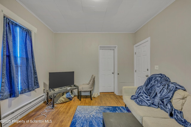 living area with hardwood / wood-style flooring, ornamental molding, and a baseboard radiator