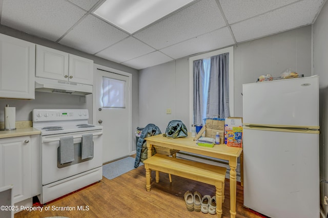 kitchen featuring a drop ceiling, white appliances, white cabinets, and light hardwood / wood-style floors