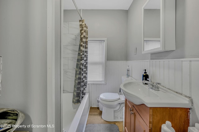 full bathroom featuring wood-type flooring, vanity, toilet, and shower / bath combo with shower curtain