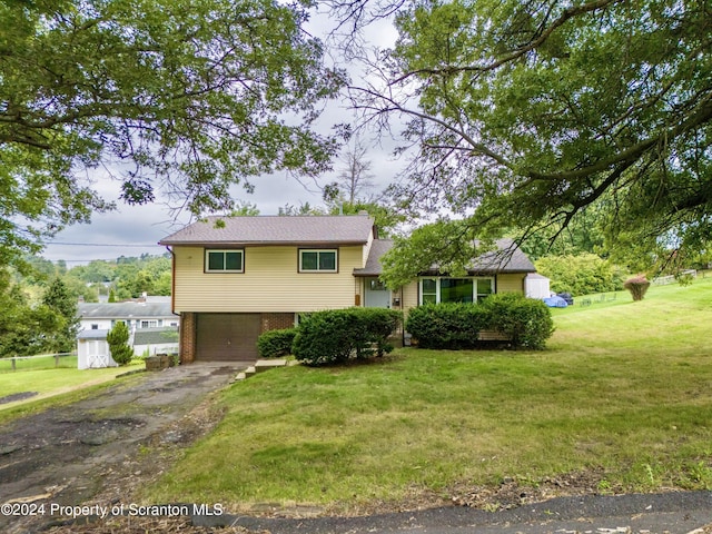 tri-level home with a front yard and a garage