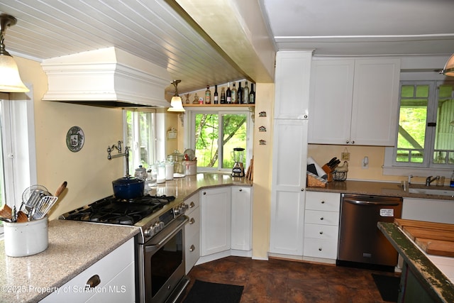 519 Sutton Rd, New Milford, PA 18834 - kitchen with stainless steel appliances, custom exhaust hood, white cabinetry, and decorative light fixtures