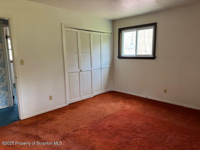 unfurnished bedroom with baseboards, a closet, and carpet floors