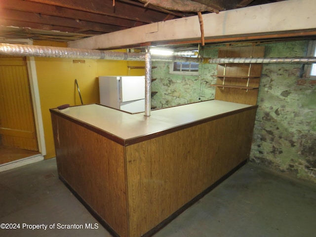 basement featuring white fridge