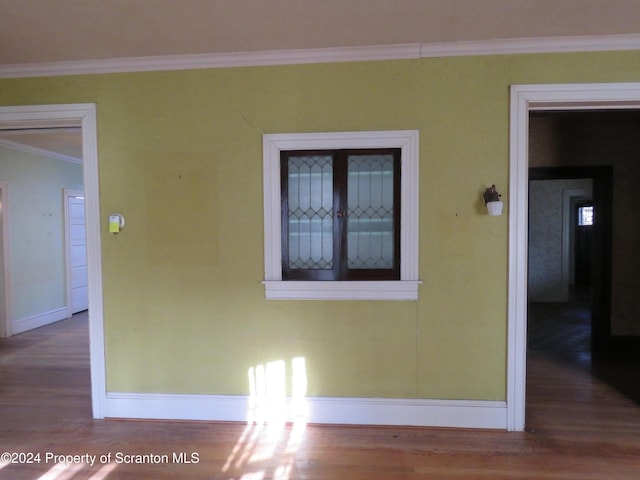 spare room featuring ceiling fan, radiator heating unit, a healthy amount of sunlight, and hardwood / wood-style floors