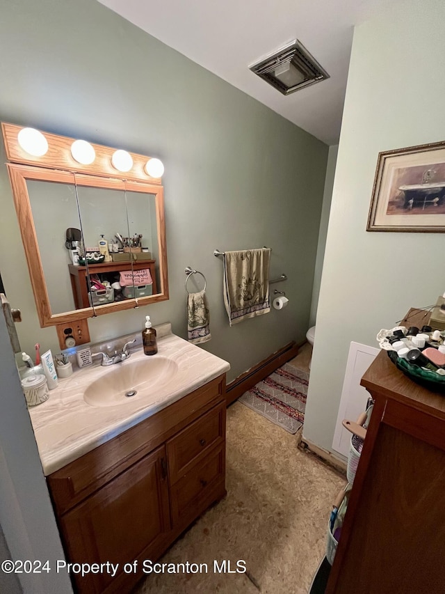 bathroom featuring vanity and toilet