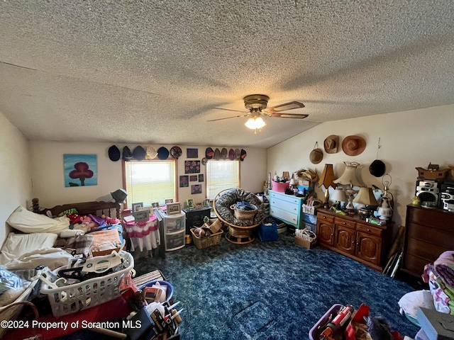 carpeted bedroom featuring ceiling fan and a textured ceiling