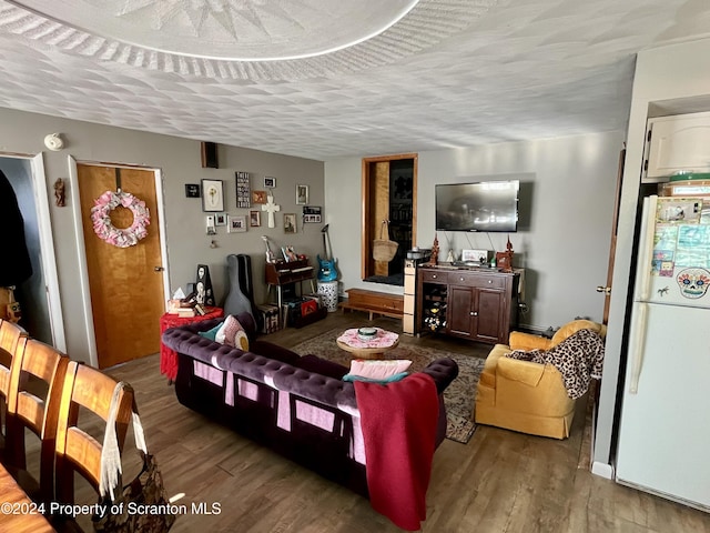 living room with hardwood / wood-style floors and a textured ceiling