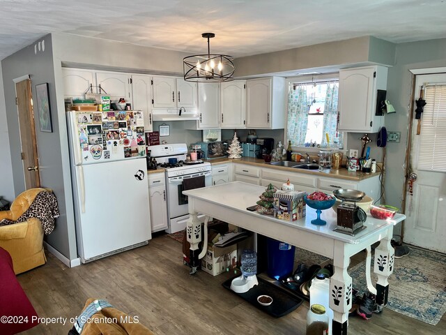 kitchen with hardwood / wood-style floors, pendant lighting, white cabinetry, sink, and white appliances