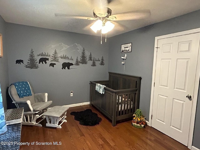 85 Cranberry Ter, Duryea, PA 18642 - bedroom featuring wood finished floors, a crib, and a ceiling fan