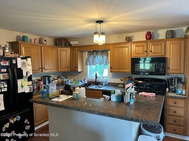 85 Cranberry Ter, Duryea, PA 18642 - kitchen with black appliances, dark countertops, a kitchen island, pendant lighting, and brown cabinets